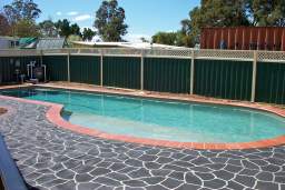 Freeform concrete pool with stencilled concrete surround
